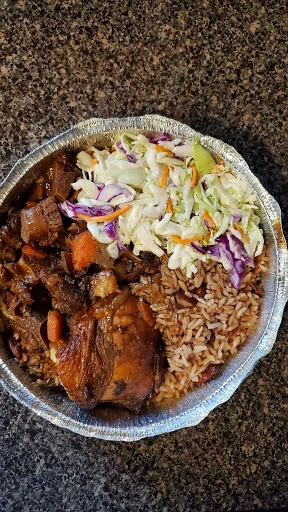 Jerk chicken with rice and peas and coleslaw at J&K Cuisine