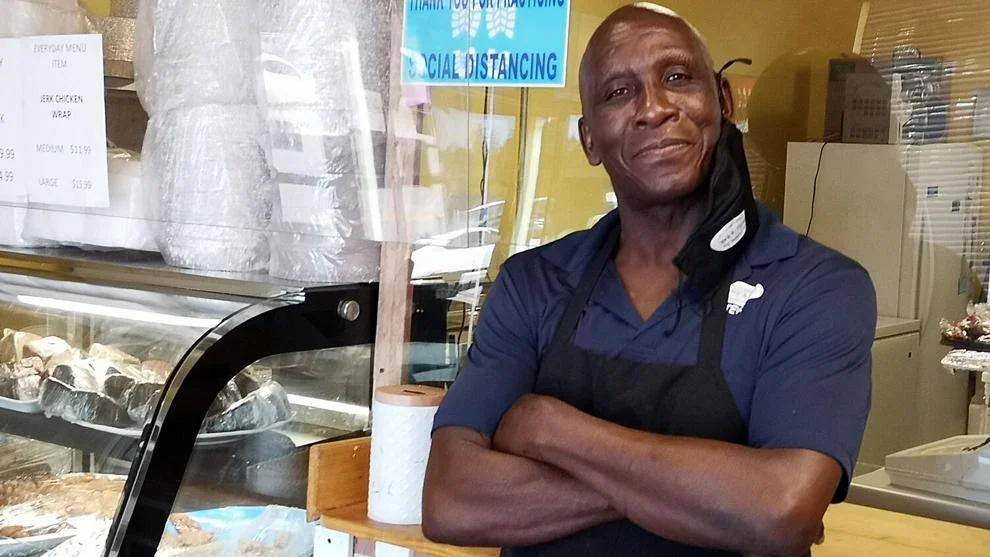 The owner of J&K Cuisine behind the counter at the restaurant